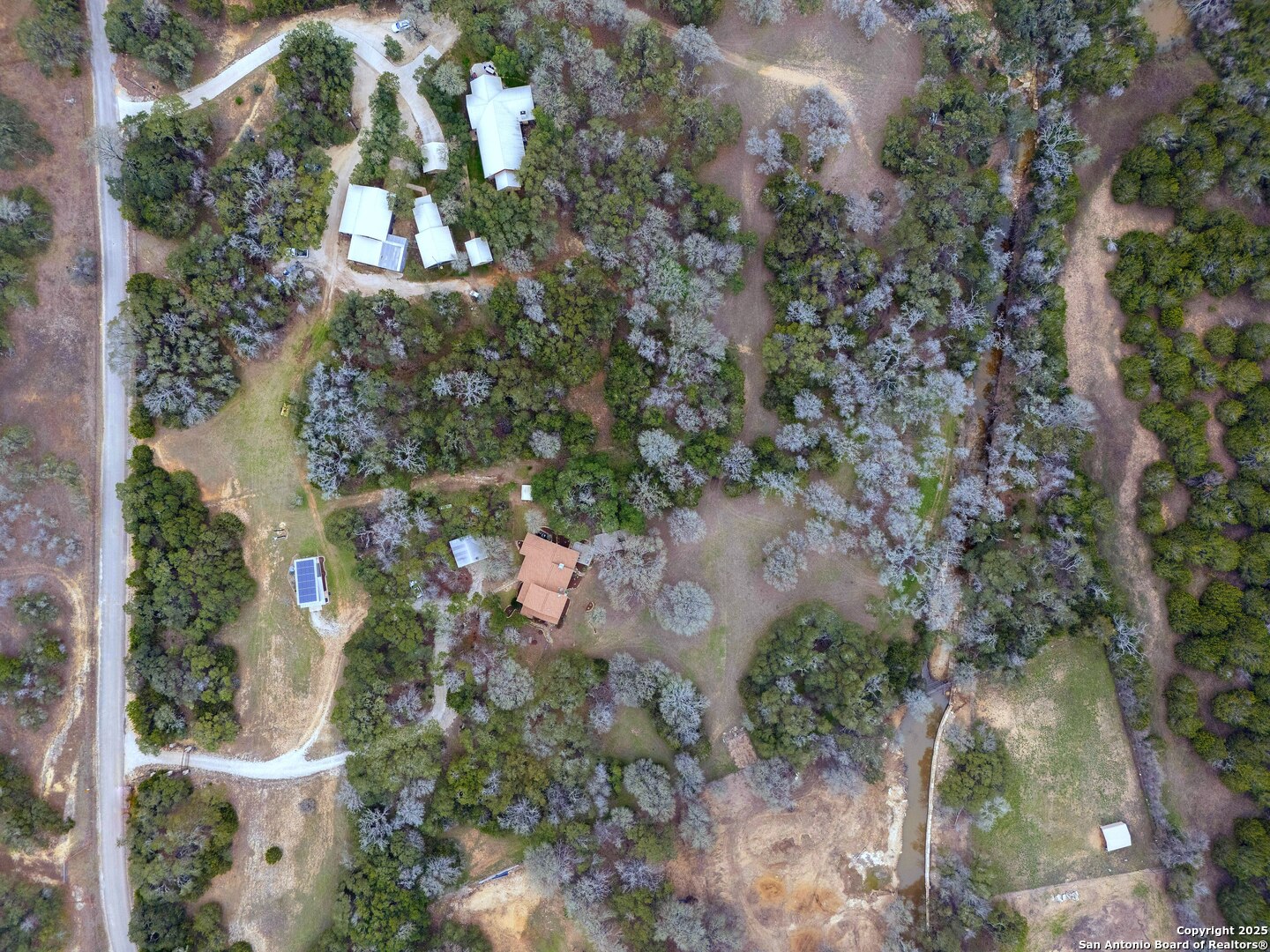 2147 Tejas Trail Blanco, TX 78606 - Photo 4 of 33 an aerial view of residential house with outdoor space and trees all around