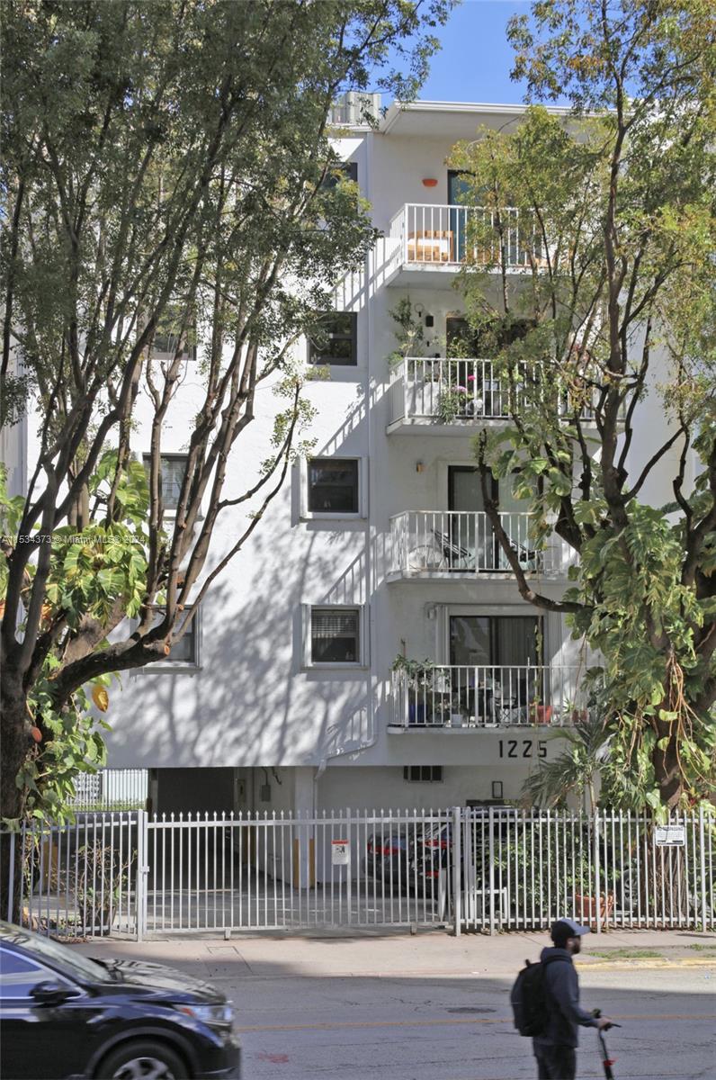 Flamingo-Lummus Miami Beach, FL 33139 - Photo 15 of 16 a front view of a residential apartment building with a yard