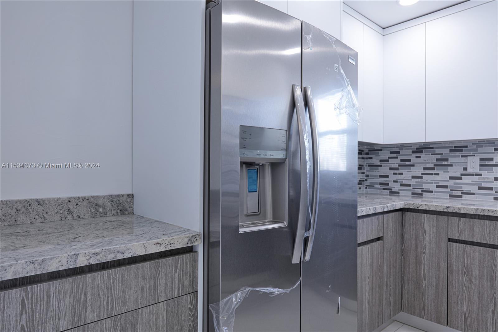 Flamingo-Lummus Miami Beach, FL 33139 - Photo 8 of 16 a kitchen with a granite countertop sink and refrigerator