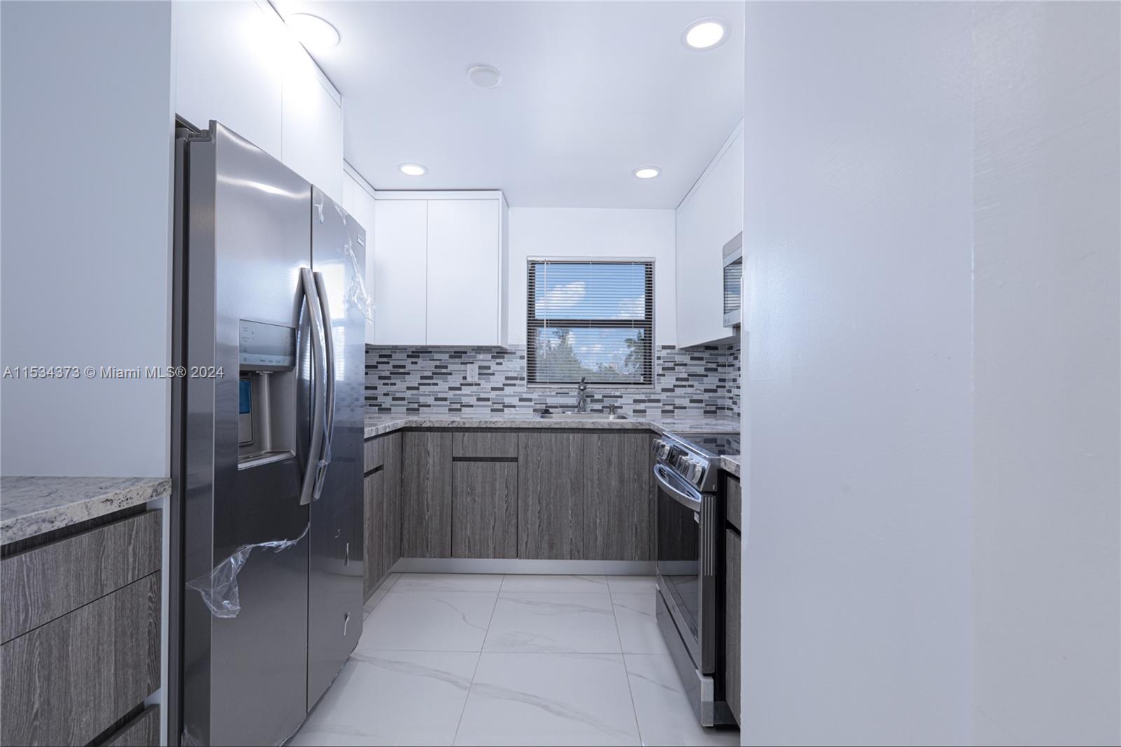 Flamingo-Lummus Miami Beach, FL 33139 - Photo 9 of 16 a kitchen with a refrigerator and a sink