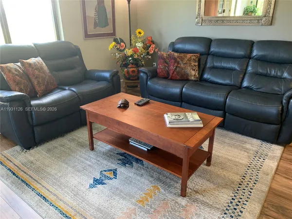 a living room with furniture and wooden floor