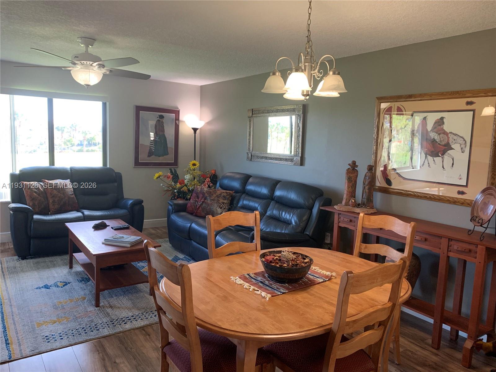 5463 Southeast Miles Grant Road, Unit 210 Stuart, FL 34997 - Photo 20 of 53 a view of a dining room with furniture window and wooden floor