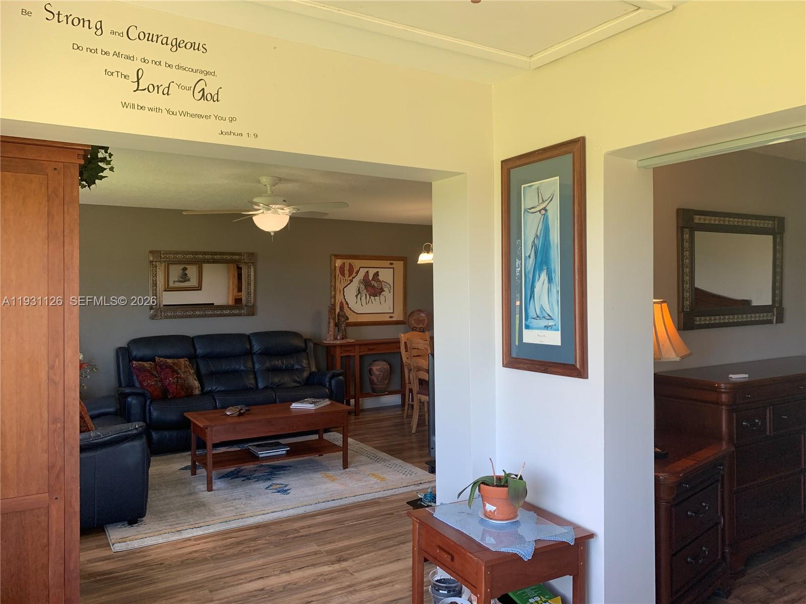 5463 Southeast Miles Grant Road, Unit 210 Stuart, FL 34997 - Photo 26 of 53 a living room with furniture and a wooden floor