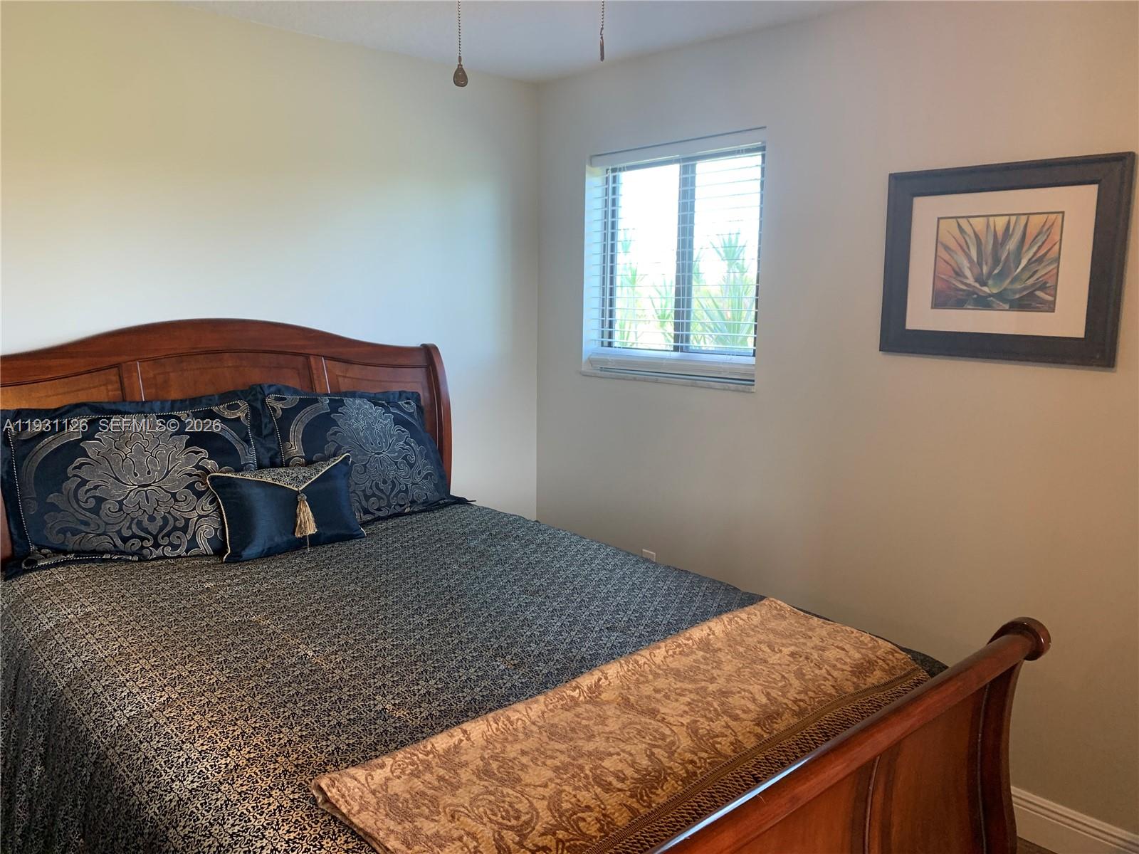 5463 Southeast Miles Grant Road, Unit 210 Stuart, FL 34997 - Photo 30 of 53 a bedroom with a bed and a window