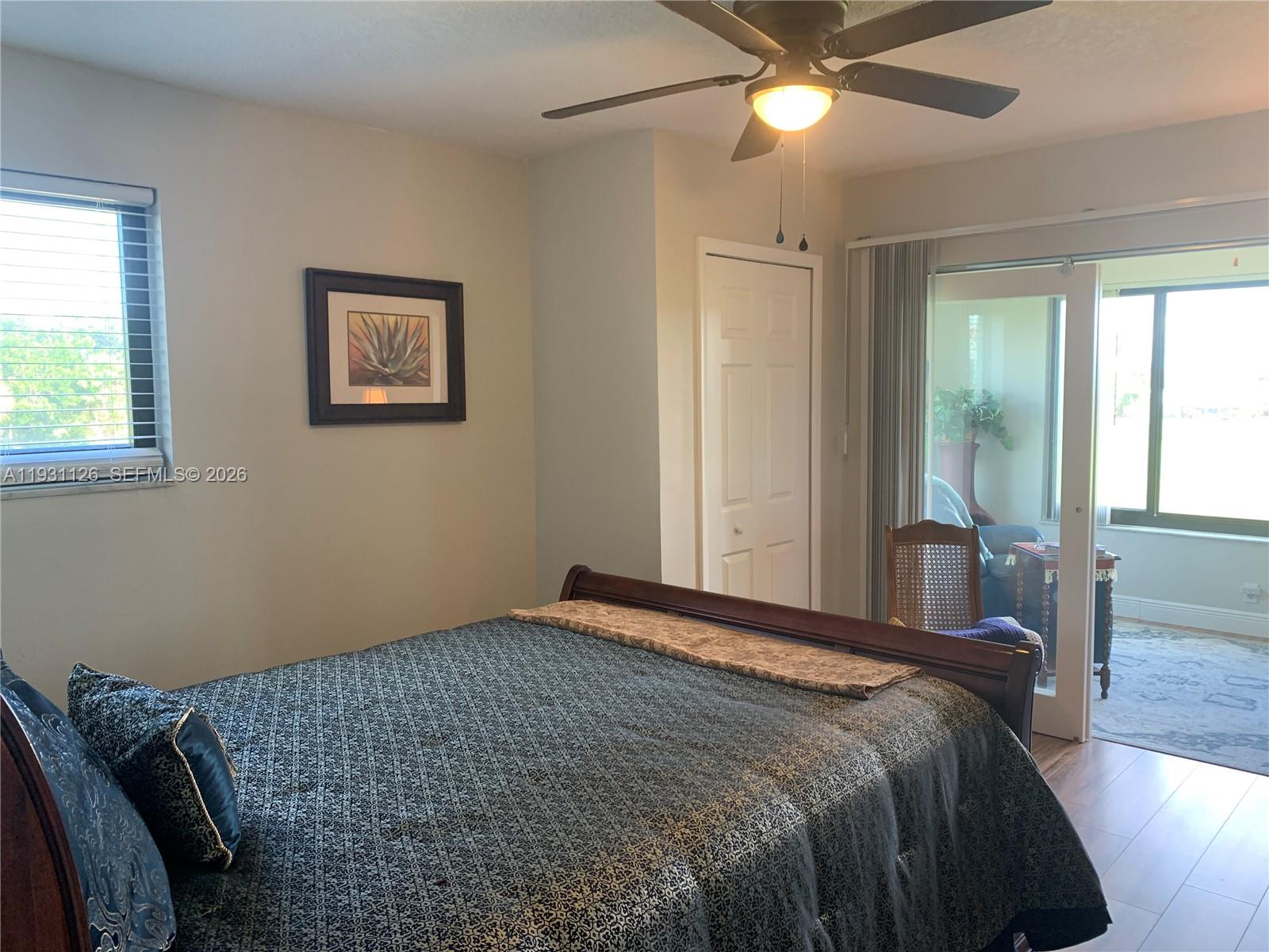 5463 Southeast Miles Grant Road, Unit 210 Stuart, FL 34997 - Photo 31 of 53 a bedroom with a bed and a chandelier