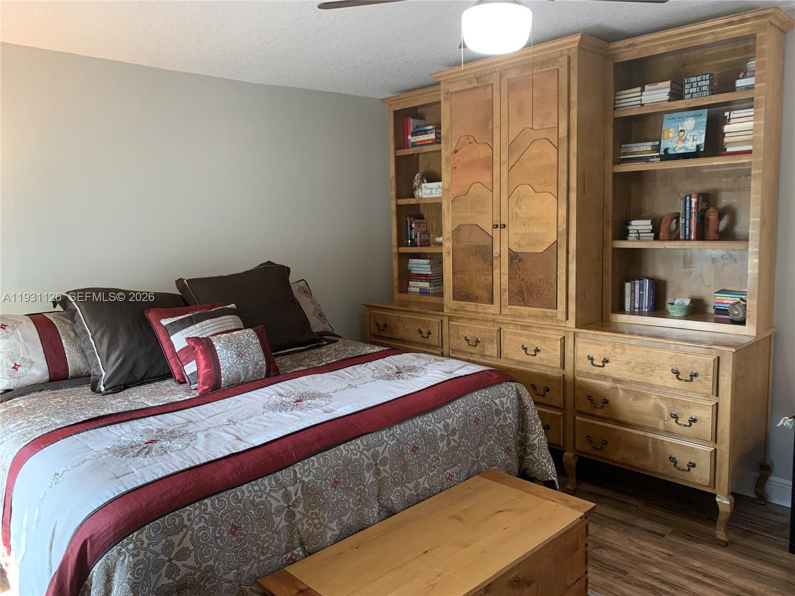 5463 Southeast Miles Grant Road, Unit 210 Stuart, FL 34997 - Photo 37 of 53 a bedroom with a bed and dresser