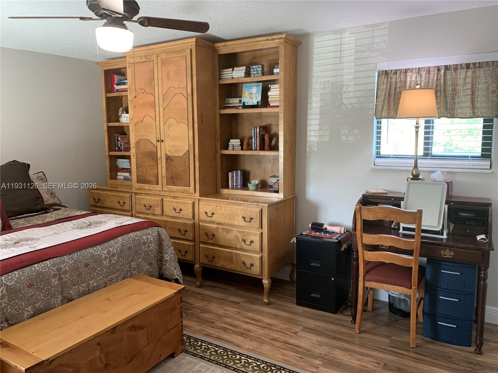 5463 Southeast Miles Grant Road, Unit 210 Stuart, FL 34997 - Photo 41 of 53 a bedroom with a bed and a window