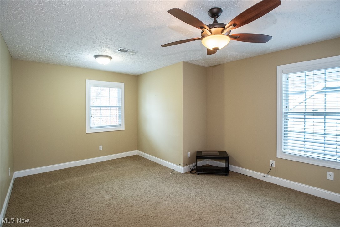 630 Rundle Street Lagrange, OH 44050 - Photo 33 of 49 Spare room with light colored carpet, a textured ceiling, and ceiling fan