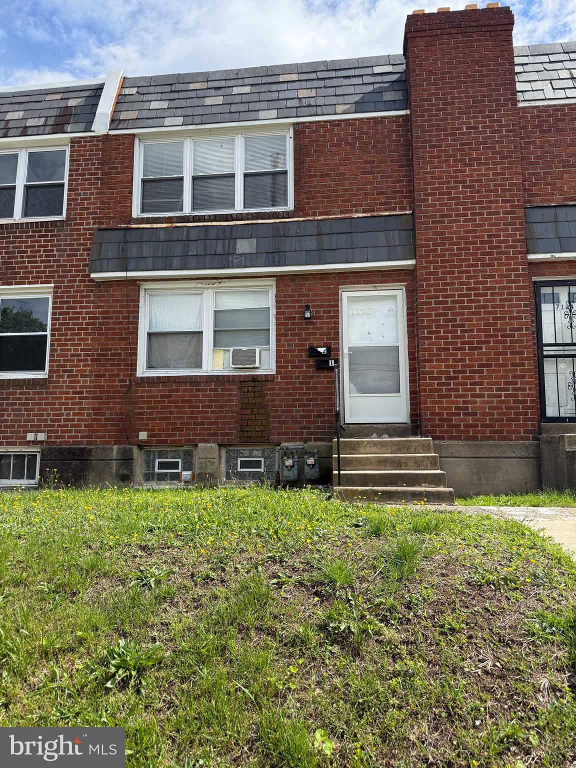 a brick building with a yard