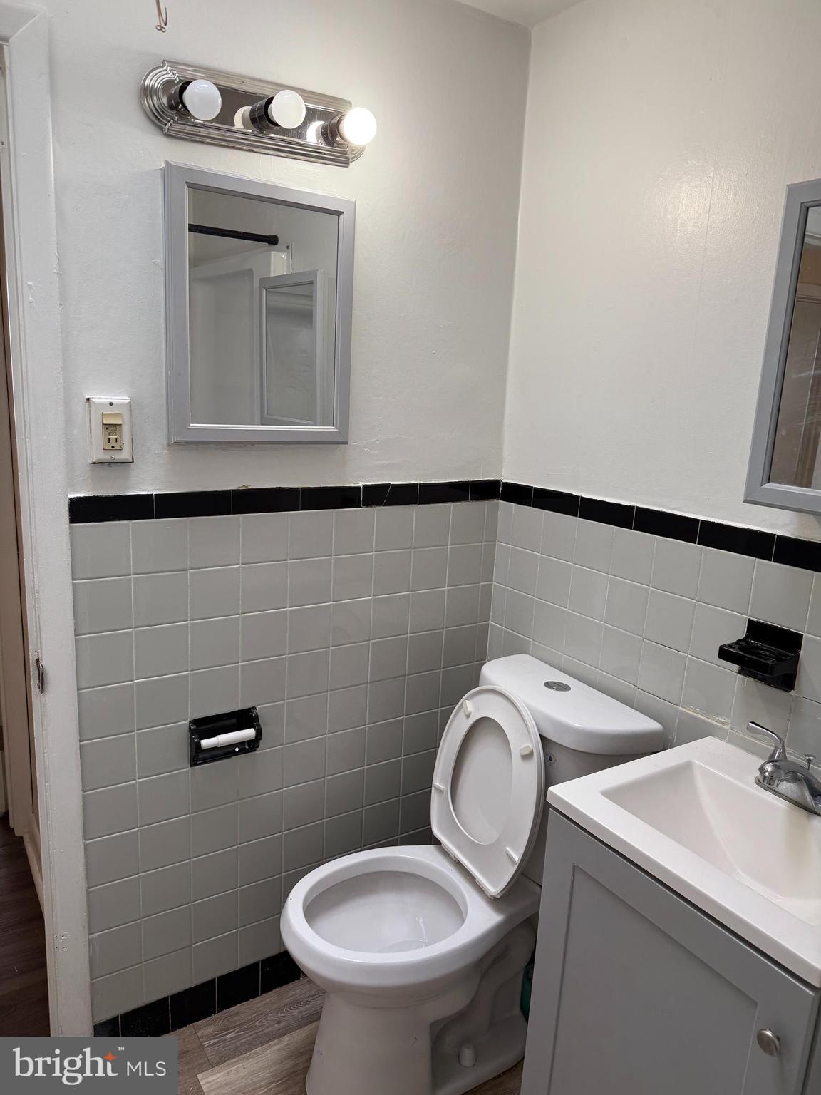 7122 7122-2nd Road Upper Darby, PA 19082 - Photo 10 of 12 a bathroom with a toilet sink vanity and mirror