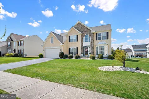 a view of a house with a yard and front view of a house