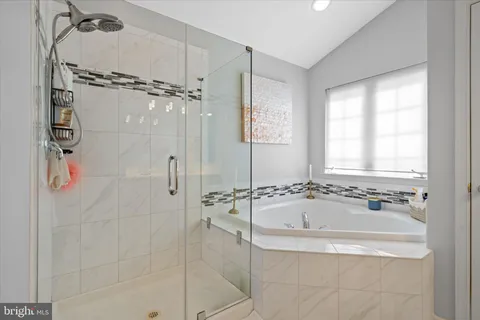 a bathroom with a tub and a shower