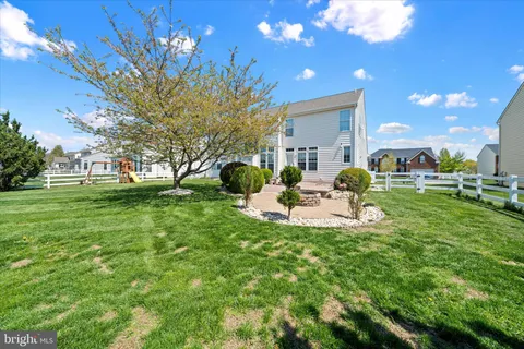 a view of a house with backyard porch and sitting area
