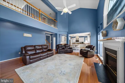 a living room with furniture a fireplace and a large window