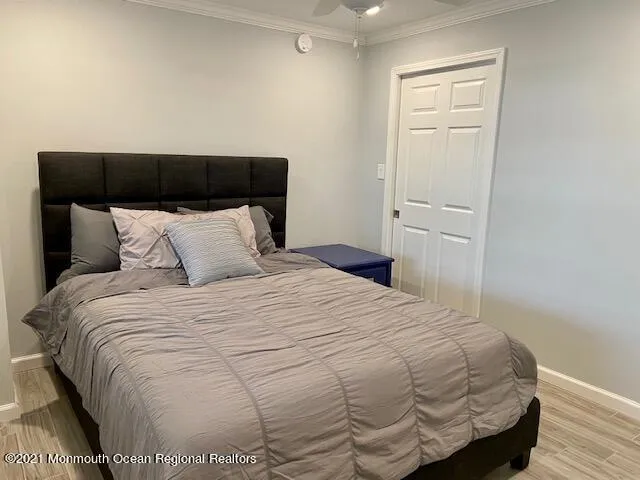 a bedroom with a bed and a night stand