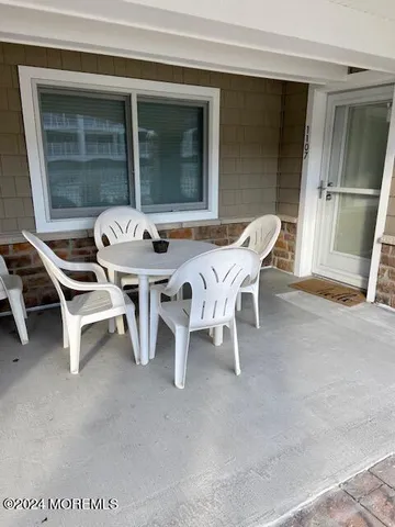 a outdoor seating area with furniture and a window