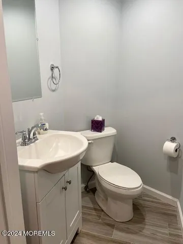a white toilet sitting next to a bathroom sink