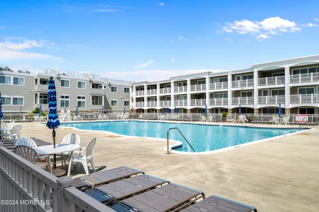 a view of a house with swimming pool and sitting area