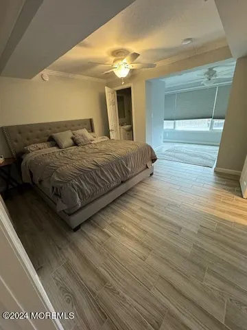 a spacious bedroom with a bed and a mirror