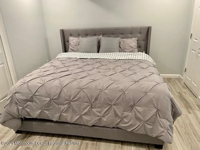 a bed sitting in a bedroom next to a window