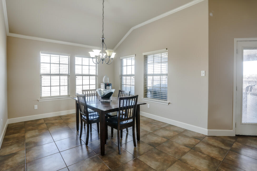 6502 71st Street Lubbock, TX 79424 - Photo 11 of 21 a view of a dining room with furniture and windows