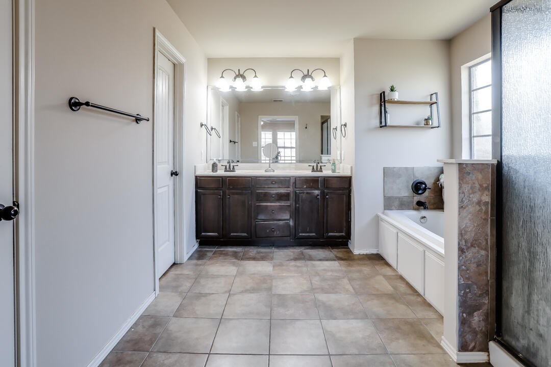 6502 71st Street Lubbock, TX 79424 - Photo 13 of 21 a large kitchen with a stove top oven and cabinets