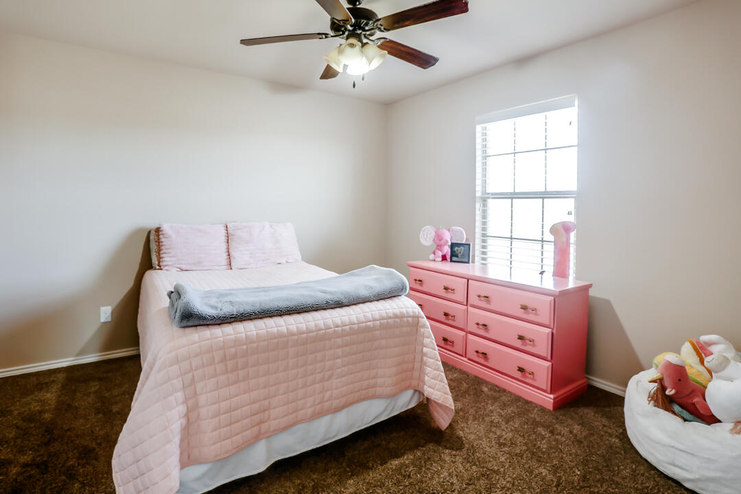 6502 71st Street Lubbock, TX 79424 - Photo 18 of 21 a bedroom with a bed and a window