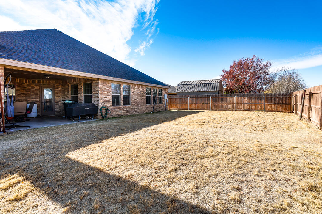 6502 71st Street Lubbock, TX 79424 - Photo 20 of 21 a view of a house with a yard