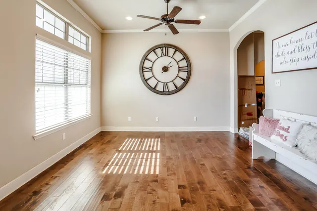 a view of a room with wooden floor and a window