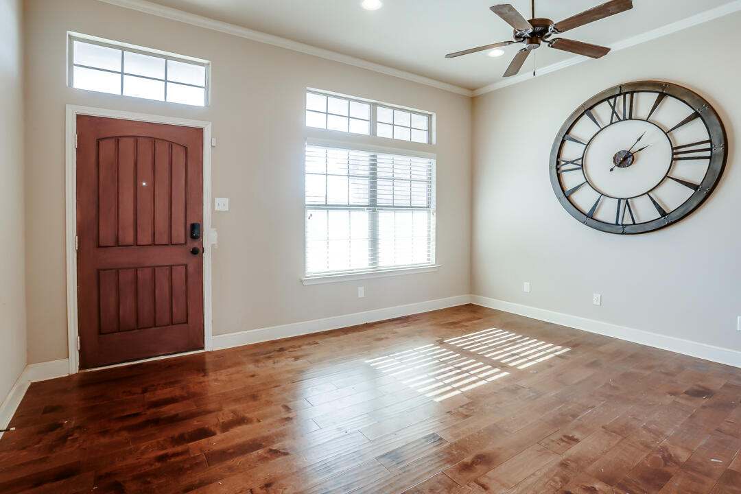 6502 71st Street Lubbock, TX 79424 - Photo 6 of 21 an empty room with wooden floor closet and windows