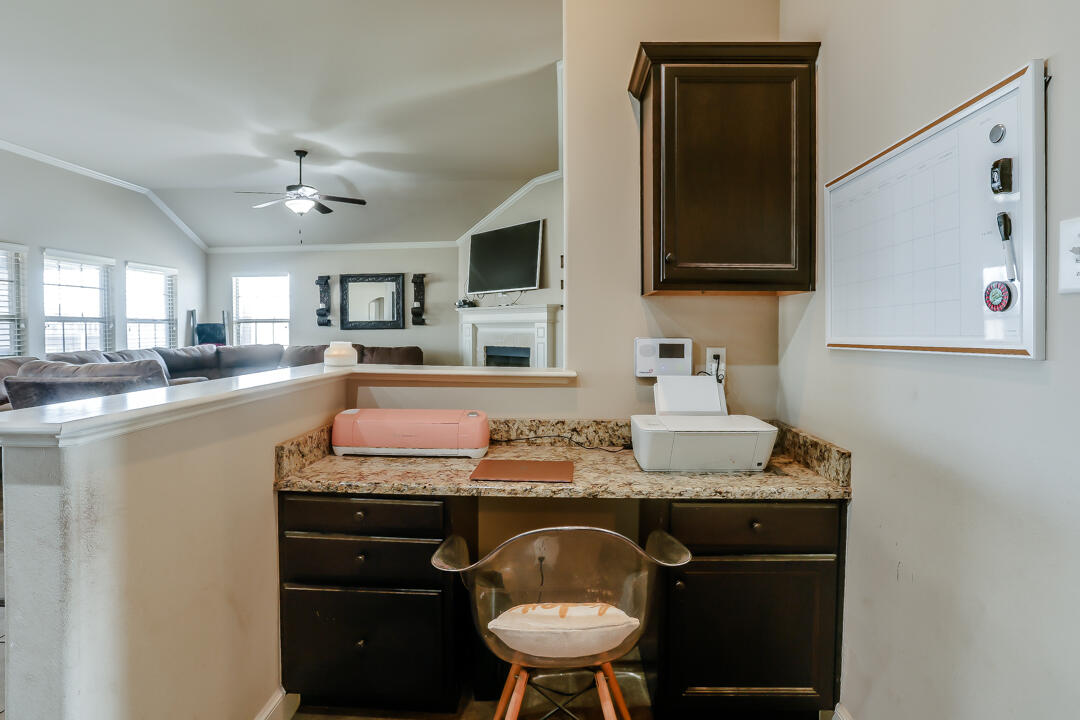 6502 71st Street Lubbock, TX 79424 - Photo 10 of 21 a kitchen with a sink cabinets and wooden floor