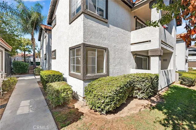 front view of a brick house with a yard