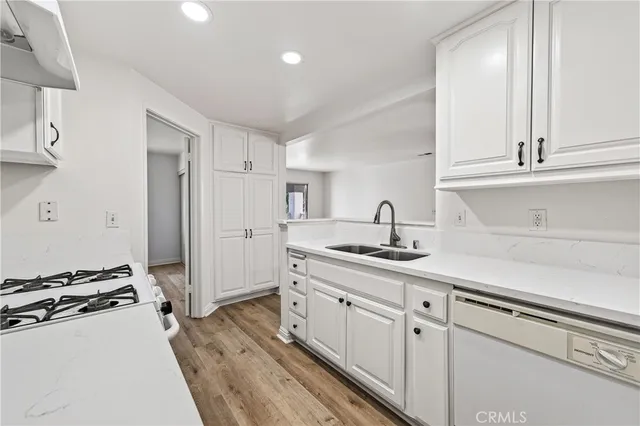 a kitchen with a sink stove and refrigerator