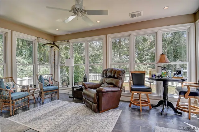 a living room with furniture a fireplace and a table