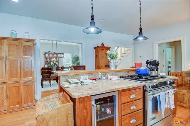 a dining room with a stove and chairs