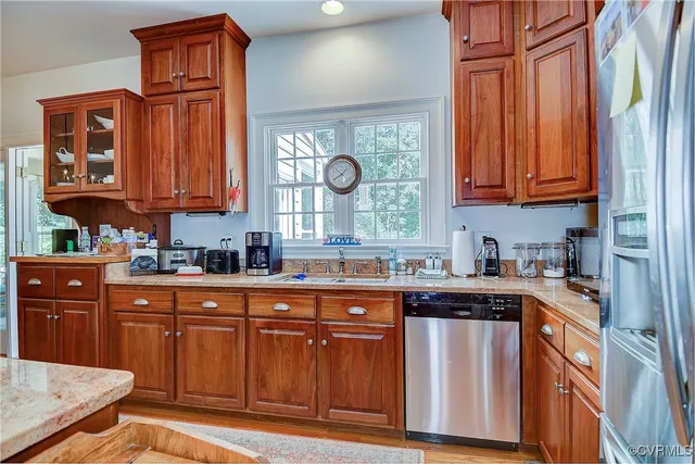 a view of a dining room with furniture a chandelier and wooden floor
