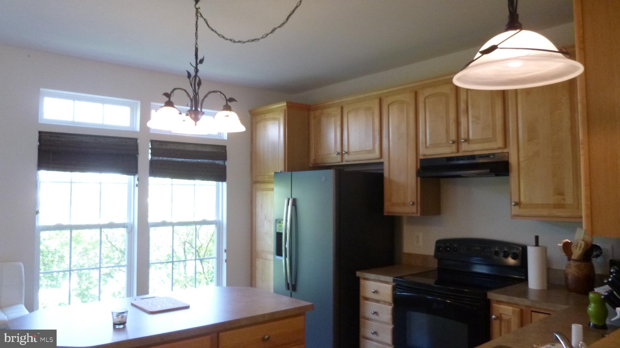 310 Monroe Point Drive Colonial Beach, VA 22443 - Photo 11 of 36 a kitchen with stainless steel appliances granite countertop a sink and a refrigerator