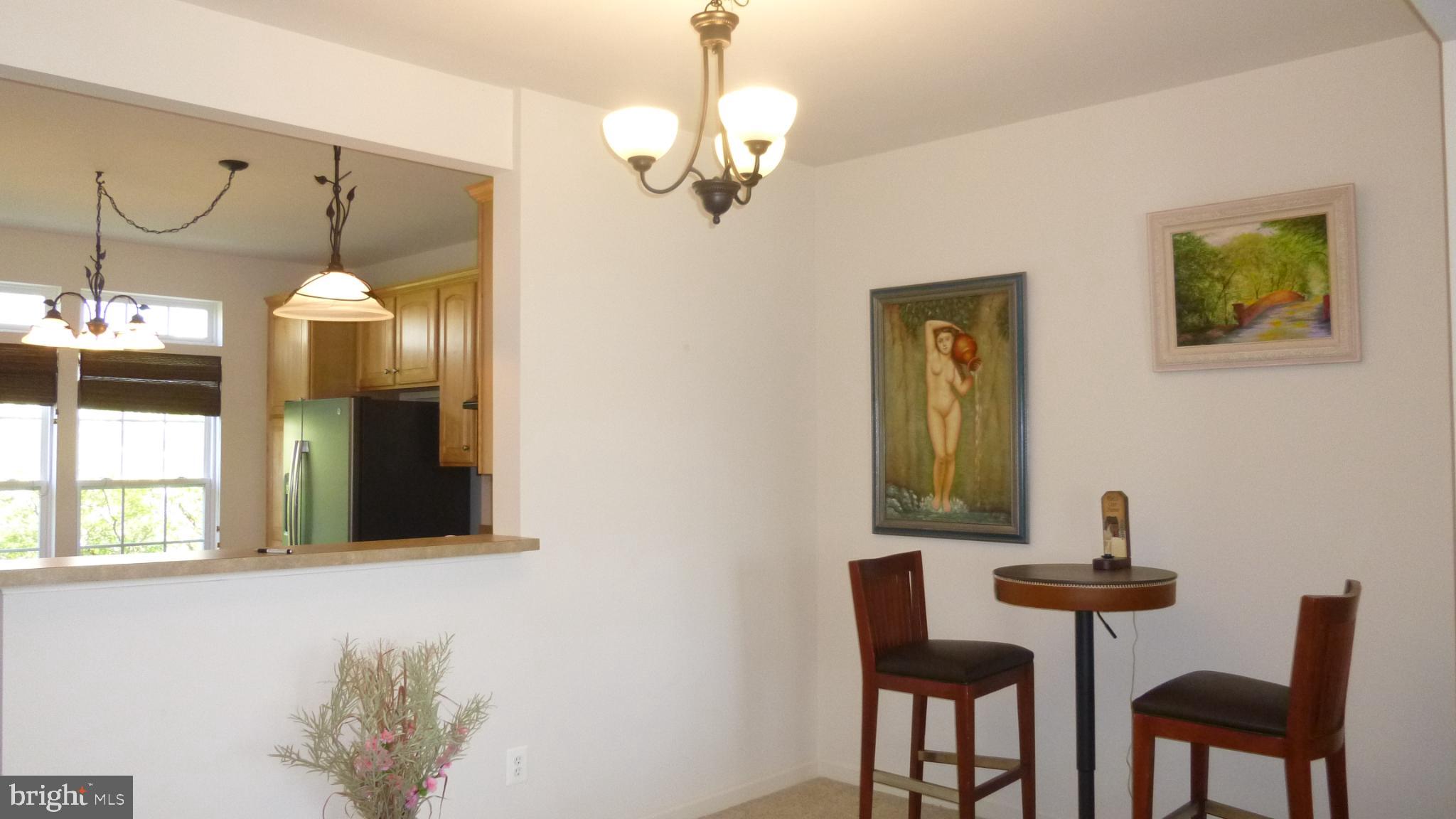 310 Monroe Point Drive Colonial Beach, VA 22443 - Photo 15 of 36 a view of a dining room with furniture and chandelier