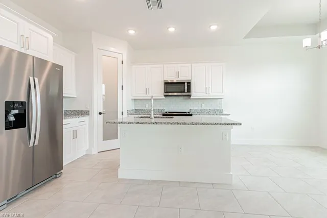 a large kitchen with cabinets and stainless steel appliances