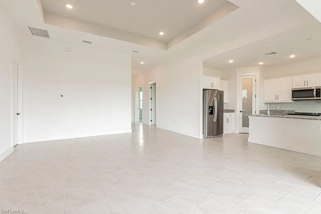 a view of an empty room with a refrigerator