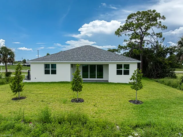 a front view of house with yard and green space