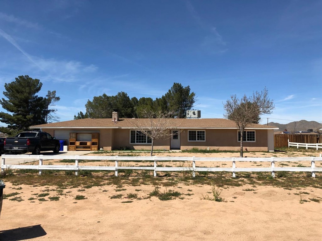 16010 Osage Road Apple Valley, CA 92307 - Photo 1 of 1 a front view of a house with swimming pool