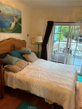 a bedroom with a bed and a large window