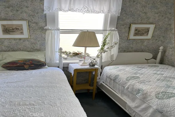 a bedroom with a bed and a lamp