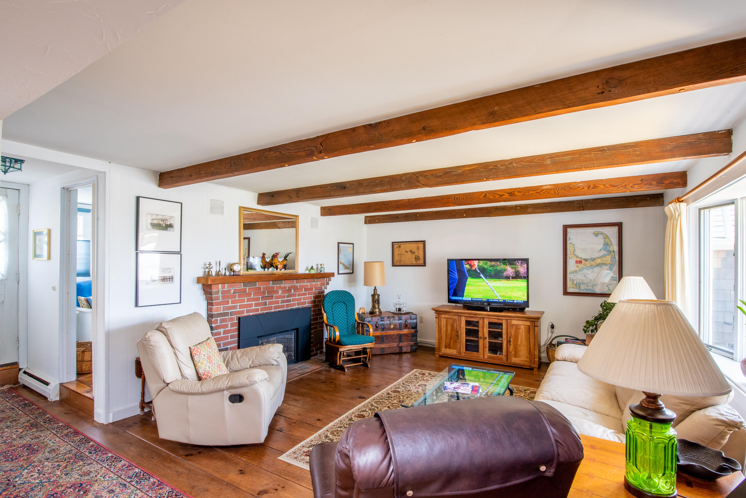 168 Shore Road, Unit 13 Truro, MA 02666 - Photo 3 of 28 a living room with furniture and a fireplace