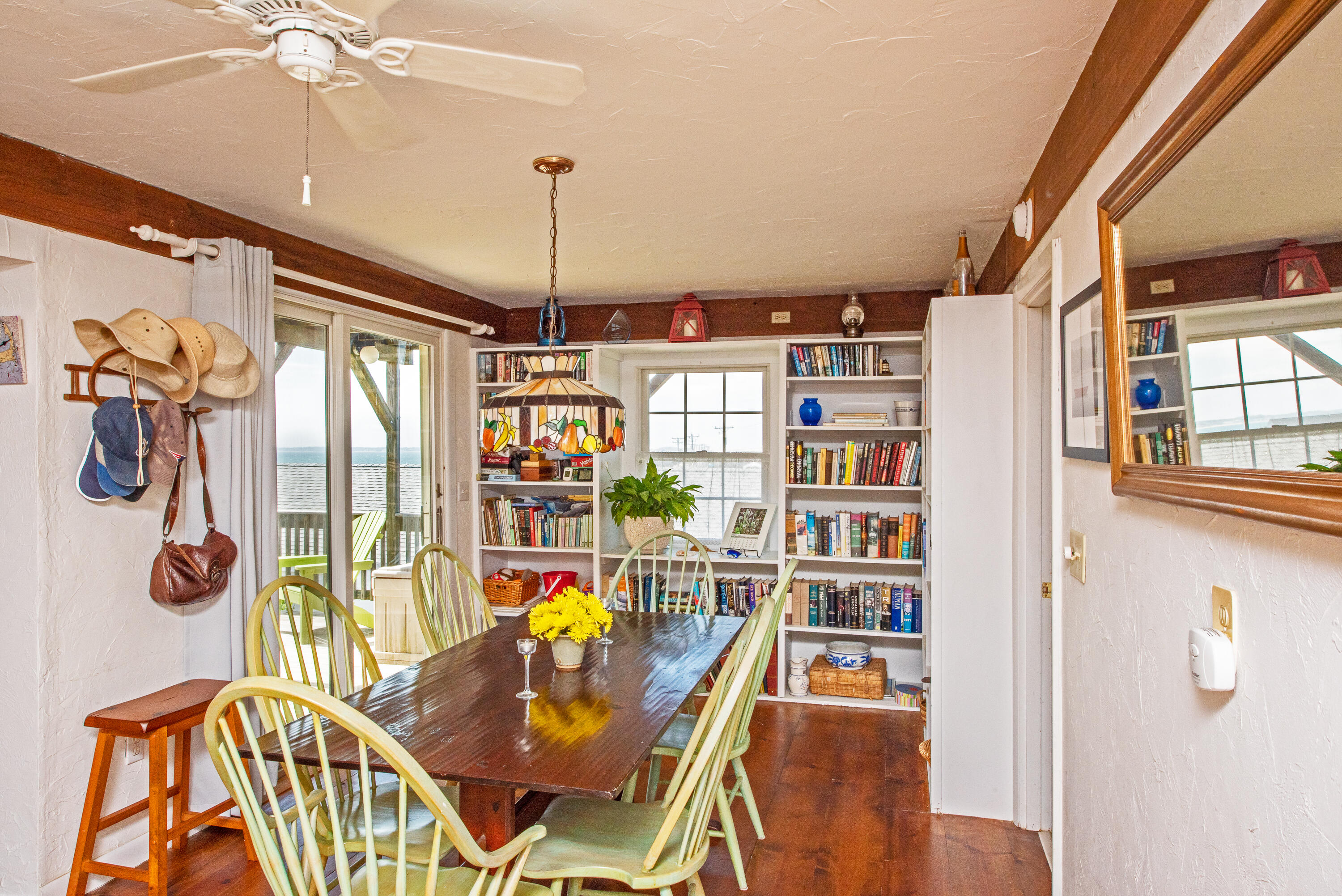 168 Shore Road, Unit 13 Truro, MA 02666 - Photo 6 of 28 a living room with lots of furniture and a chandelier