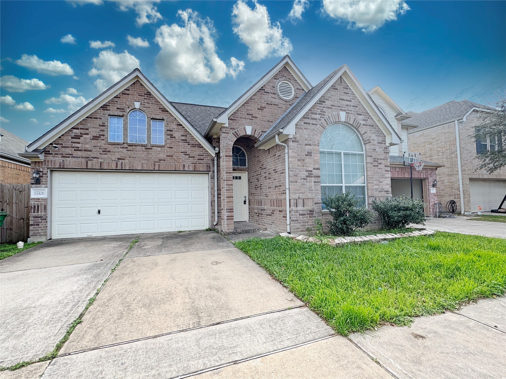 a front view of a house with a yard and garage