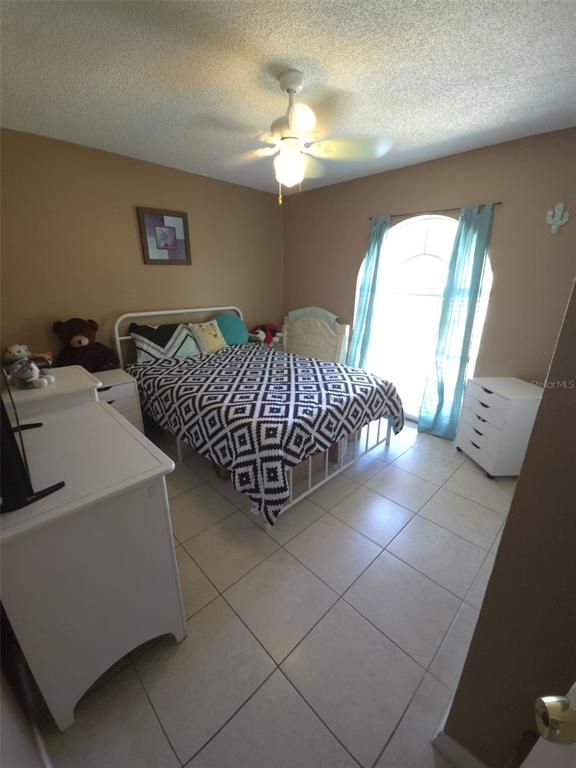7818 Lewis Road Lakeland, FL 33810 - Photo 9 of 13 a living room with a couch and a chandelier