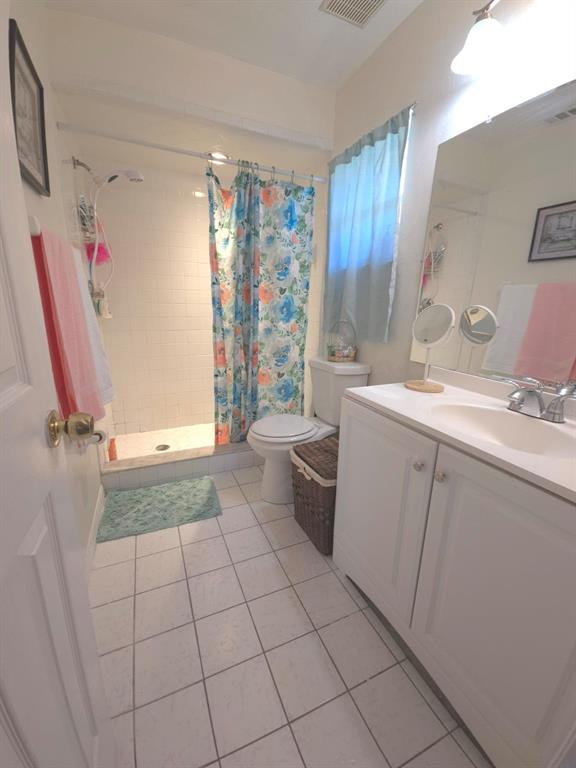 7818 Lewis Road Lakeland, FL 33810 - Photo 10 of 13 a bathroom with a sink a toilet and a shower