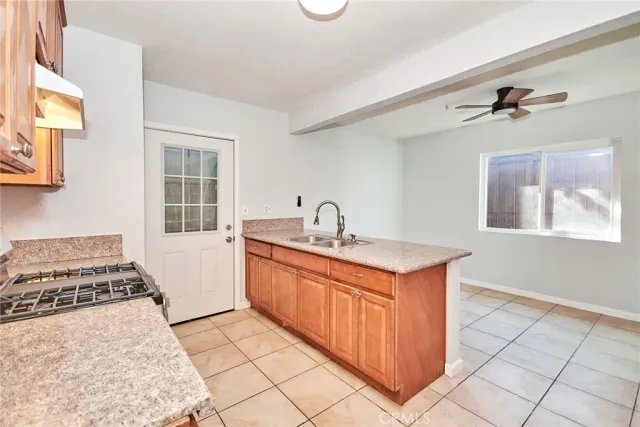 a kitchen with stainless steel appliances granite countertop a sink stove and cabinets